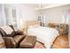 Cozy bedroom with lots of light, hardwood floors, and a comfortable bed at 899 Wendover Rd # 29, Statesville, NC 28677