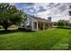 Charming single-story home features a covered porch, lush lawn, mature trees, and traditional architectural details at 899 Wendover Rd # 29, Statesville, NC 28677