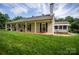 Exterior of home featuring a covered porch, lush lawn, and mature trees at 899 Wendover Rd # 29, Statesville, NC 28677