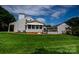 Exterior of home featuring lush lawn, mature trees, a deck and a screened porch at 899 Wendover Rd # 29, Statesville, NC 28677