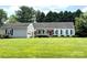 Charming single-story home featuring a lush green lawn, classic shutters, and a vibrant red front door at 899 Wendover Rd # 29, Statesville, NC 28677