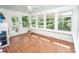 Light-filled sunroom with many windows, white paneling, ceramic tile floor and a ceiling fan for year-round comfort at 899 Wendover Rd # 29, Statesville, NC 28677