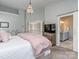 Bright bedroom features a decorative chandelier and a sliding door entrance to the bathroom at 9422 Olivia Ln, Charlotte, NC 28277