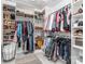 Walk-in closet with custom shelving, storage baskets, and an abundance of hanging clothes at 9422 Olivia Ln, Charlotte, NC 28277