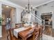 Open dining room with a wooden table, staircase, and access to a living area at 9422 Olivia Ln, Charlotte, NC 28277