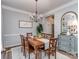 Dining room with a wooden table, chandelier lighting, and crown molding at 9422 Olivia Ln, Charlotte, NC 28277