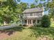 Beautiful two-story home with a classic front porch, well-maintained lawn, and mature trees at 9422 Olivia Ln, Charlotte, NC 28277