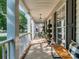 Inviting front porch with rocking chairs, accent plants, and stylish lighting fixtures at 9422 Olivia Ln, Charlotte, NC 28277