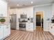 Bright kitchen with stainless steel appliances, white cabinetry, and granite countertops at 9422 Olivia Ln, Charlotte, NC 28277