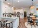 Open kitchen featuring a breakfast bar, stainless steel appliances, and modern pendant lighting at 9422 Olivia Ln, Charlotte, NC 28277