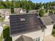 Aerial view of home featuring solar panels, green trees and a large yard at 9937 Violet Cannon Nw Dr, Concord, NC 28027