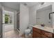 Bathroom featuring a single sink vanity, shower stall, and neutral-toned tile flooring at 9937 Violet Cannon Nw Dr, Concord, NC 28027