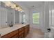 Bright bathroom with double vanity, neutral countertops and a shower with glass door at 9937 Violet Cannon Nw Dr, Concord, NC 28027