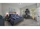 A bedroom featuring a cheerful decor with surf-themed art and vibrant furnishings at 9937 Violet Cannon Nw Dr, Concord, NC 28027