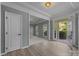 Bright foyer with light wood floors leading to the living room and front door view at 9937 Violet Cannon Nw Dr, Concord, NC 28027