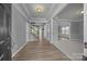 Spacious foyer showcasing wood floors, staircase and entry to the living room at 9937 Violet Cannon Nw Dr, Concord, NC 28027