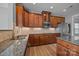 A well-lit kitchen with stainless steel appliances, granite counters, and wood cabinets at 9937 Violet Cannon Nw Dr, Concord, NC 28027