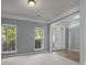Cozy living room featuring carpeted floors and large windows, providing plenty of natural light at 9937 Violet Cannon Nw Dr, Concord, NC 28027