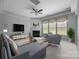 Cozy living room features a fireplace, large windows, and comfortable seating at 9937 Violet Cannon Nw Dr, Concord, NC 28027