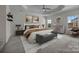 Stylish primary bedroom with a tray ceiling, neutral tones and ample natural light at 9937 Violet Cannon Nw Dr, Concord, NC 28027