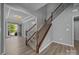 Elegant staircase with wood and iron railing, connecting the floors with style and class at 9937 Violet Cannon Nw Dr, Concord, NC 28027