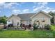 Well-maintained backyard with lush lawn, patio area, and decorative landscaping at 10211 Dominion Village Dr, Charlotte, NC 28269