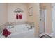 Relaxing bathroom featuring a luxurious jetted tub and a separate glass-enclosed shower for spa-like comfort at 10211 Dominion Village Dr, Charlotte, NC 28269