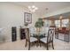 Bright dining area with a glass-top table, seating for four, and a view into the adjacent living space at 10211 Dominion Village Dr, Charlotte, NC 28269