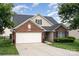 Charming single-Gathering home featuring a well-manicured lawn, brick accents and two-car garage at 10211 Dominion Village Dr, Charlotte, NC 28269