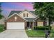 Charming single-Gathering home featuring a well-manicured lawn, brick accents and two-car garage at 10211 Dominion Village Dr, Charlotte, NC 28269