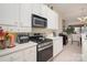 Bright kitchen featuring white cabinets, stainless steel appliances, and eat-in dining space at 10211 Dominion Village Dr, Charlotte, NC 28269