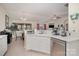 Bright kitchen featuring white cabinets, stainless steel appliances, and eat-in dining space at 10211 Dominion Village Dr, Charlotte, NC 28269