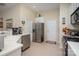 A well-lit kitchen features stainless steel appliances, white countertops, and tiled flooring for a clean and modern look at 10211 Dominion Village Dr, Charlotte, NC 28269