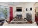 Cozy living room with a fireplace, large window and hardwood floors at 10211 Dominion Village Dr, Charlotte, NC 28269