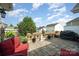Charming patio with outdoor seating, manicured landscaping, and privacy fencing at 10211 Dominion Village Dr, Charlotte, NC 28269