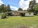 Expansive backyard featuring a covered patio and mature trees, ideal for outdoor enjoyment at 12423 Softwood Ct, Charlotte, NC 28273