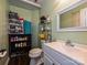 Bathroom with white vanity, filled shelves, mirror, toilet, and dark flooring at 12423 Softwood Ct, Charlotte, NC 28273