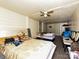 Bedroom with hardwood floors, an old ceiling fan, a bed, and a door at 12423 Softwood Ct, Charlotte, NC 28273