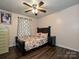 Bedroom with hardwood floors, a ceiling fan, and a full size bed at 12423 Softwood Ct, Charlotte, NC 28273