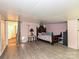Bedroom with wood-look floors, a decorative bed, and a doorway with a curtain at 12423 Softwood Ct, Charlotte, NC 28273