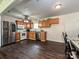 Well-lit kitchen featuring ample counter space, modern appliances, and stylish wood flooring at 12423 Softwood Ct, Charlotte, NC 28273