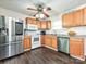 Bright kitchen featuring stainless steel appliances, granite countertops, and wood flooring at 12423 Softwood Ct, Charlotte, NC 28273