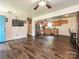 Open-concept living room featuring modern stainless steel appliances, a bright doorway, and wood flooring at 12423 Softwood Ct, Charlotte, NC 28273