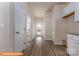 Bright hallway with wood-look flooring, white doors, and neutral paint creating a welcoming and modern aesthetic at 1255 Langston Ln, Salisbury, NC 28144