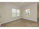 Bright bedroom with wood floors and two large windows offering natural light at 1272 Langston Ln, Salisbury, NC 28144