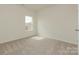 Well-lit bedroom with soft carpeting, freshly painted walls, and a large window for ample daylight at 1272 Langston Ln, Salisbury, NC 28144