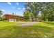 Spacious backyard featuring a detached garage, metal carport, and well-manicured lawn at 1321 Arbor Dr, Salisbury, NC 28144