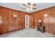 Bedroom with wood paneling, gray carpet and ceiling fan at 1321 Arbor Dr, Salisbury, NC 28144