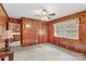 Bedroom with wood paneling, ceiling fan and doorway into another room at 1321 Arbor Dr, Salisbury, NC 28144