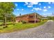 Charming brick home with a covered porch and well-maintained lawn, complemented by a gravel driveway at 1321 Arbor Dr, Salisbury, NC 28144